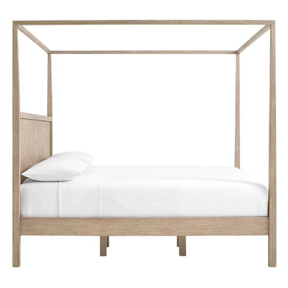 Side view of Crate & Barrel Keane Weathered Natural Solid Wood King Canopy Bed shows the tall canopy frame, solid headboard, and low-profile platform base