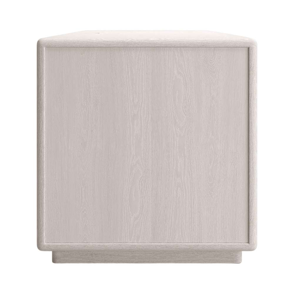 Side view of Crate & Barrel Lafayette 64" Whitewashed Desk with Outlets showing the solid side panel and low base