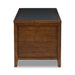 Side view of Crate & Barrel Morris 72" Chocolate Brown Writing Desk showing its paneled wood construction and black desktop insert