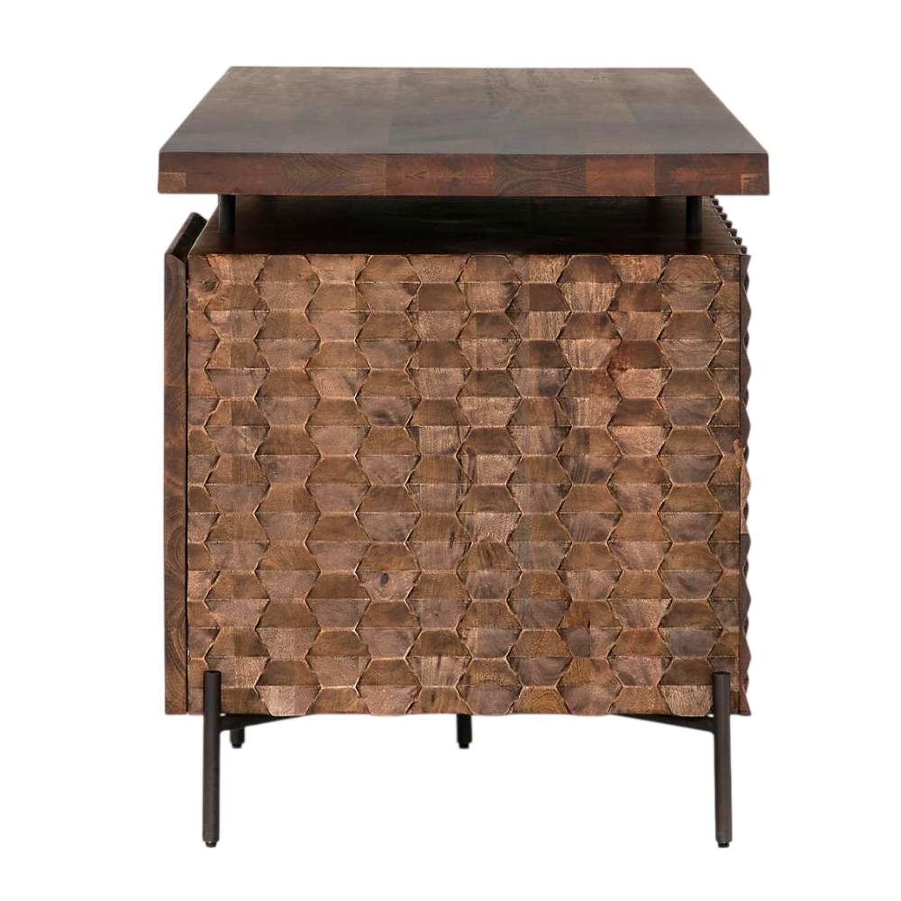 Side view of Crate & Barrel Raffael Carved Wood Executive Desk highlighting the textured carved wood panel and elevated metal frame