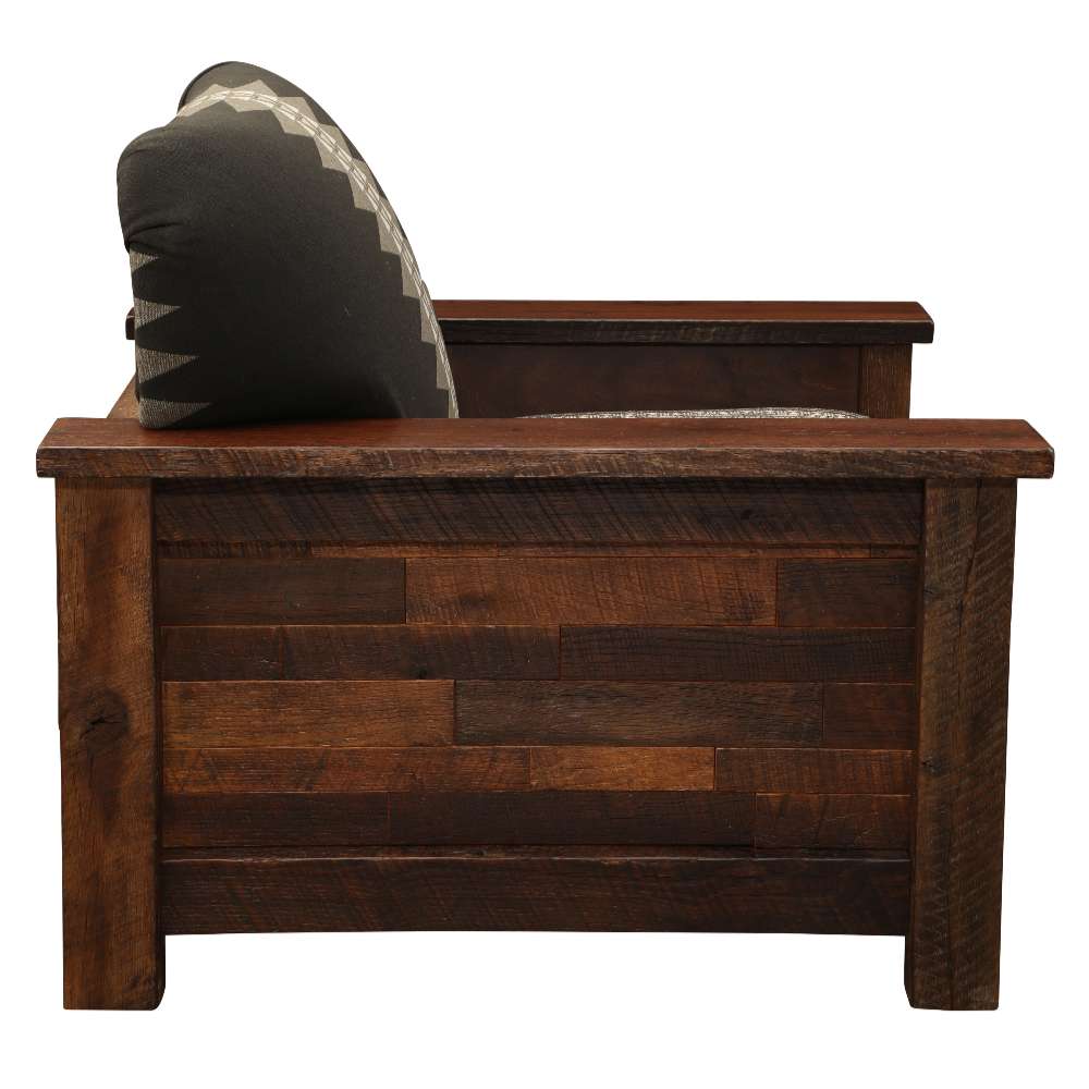 Side view of Fireside Lodge Barnwood Americana Lounge Chair highlights its sturdy wooden construction with a patterned back cushion leaning slightly backward
