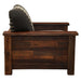 Side view of Fireside Lodge Barnwood Americana Lounge Chair highlights its sturdy wooden construction with a patterned back cushion leaning slightly backward