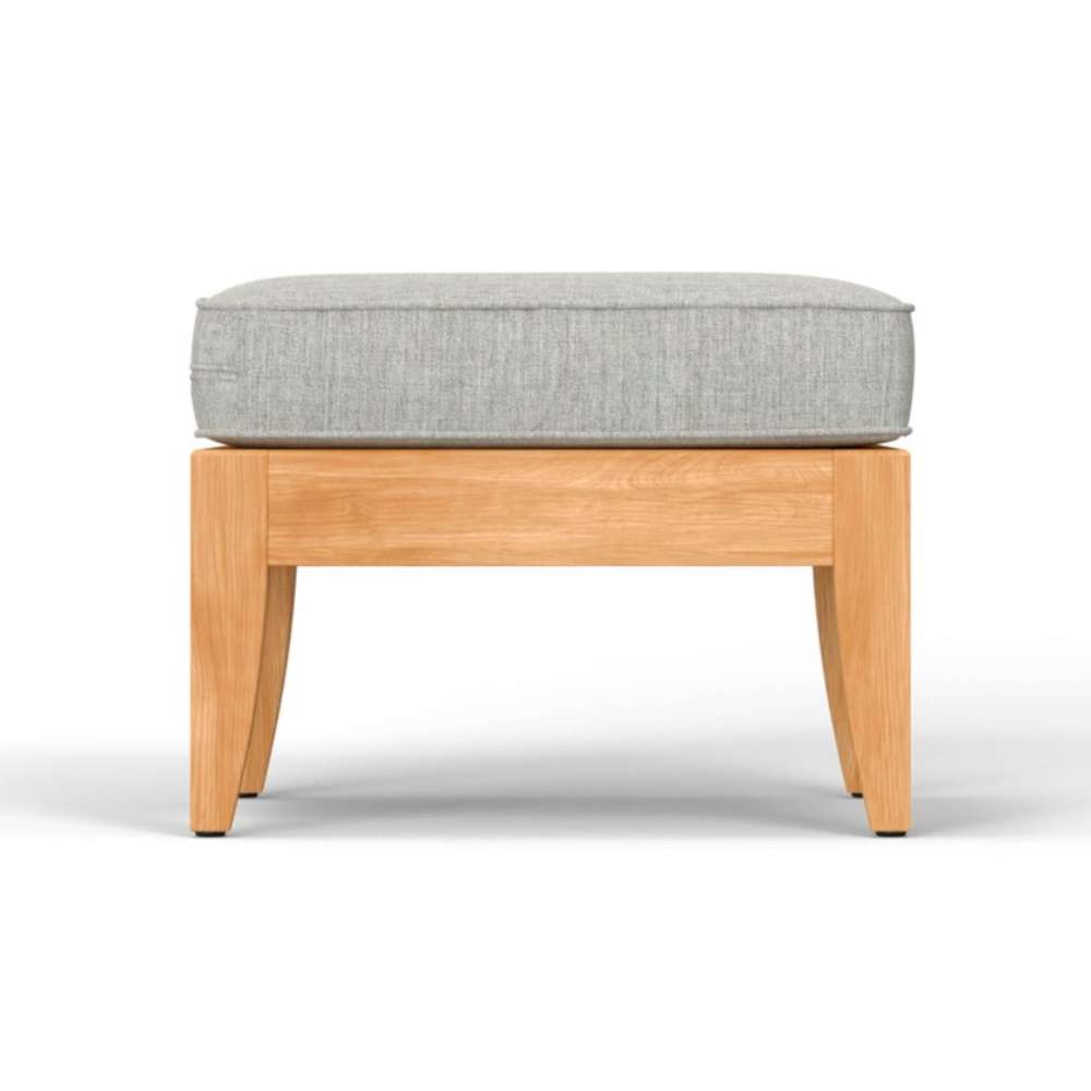 Side view of Westminster Teak Laguna Ottoman with a light gray cushion, highlighting its clean lines and sturdy wooden frame