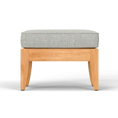 Side view of Westminster Teak Laguna Ottoman with a light gray cushion, highlighting its clean lines and sturdy wooden frame