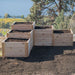 Side view of the stepped cedar planter with soil highlights the Outdoor Living Today 5.5×2 Tiered Cedar L-Shaped Raised Garden Bed at the center