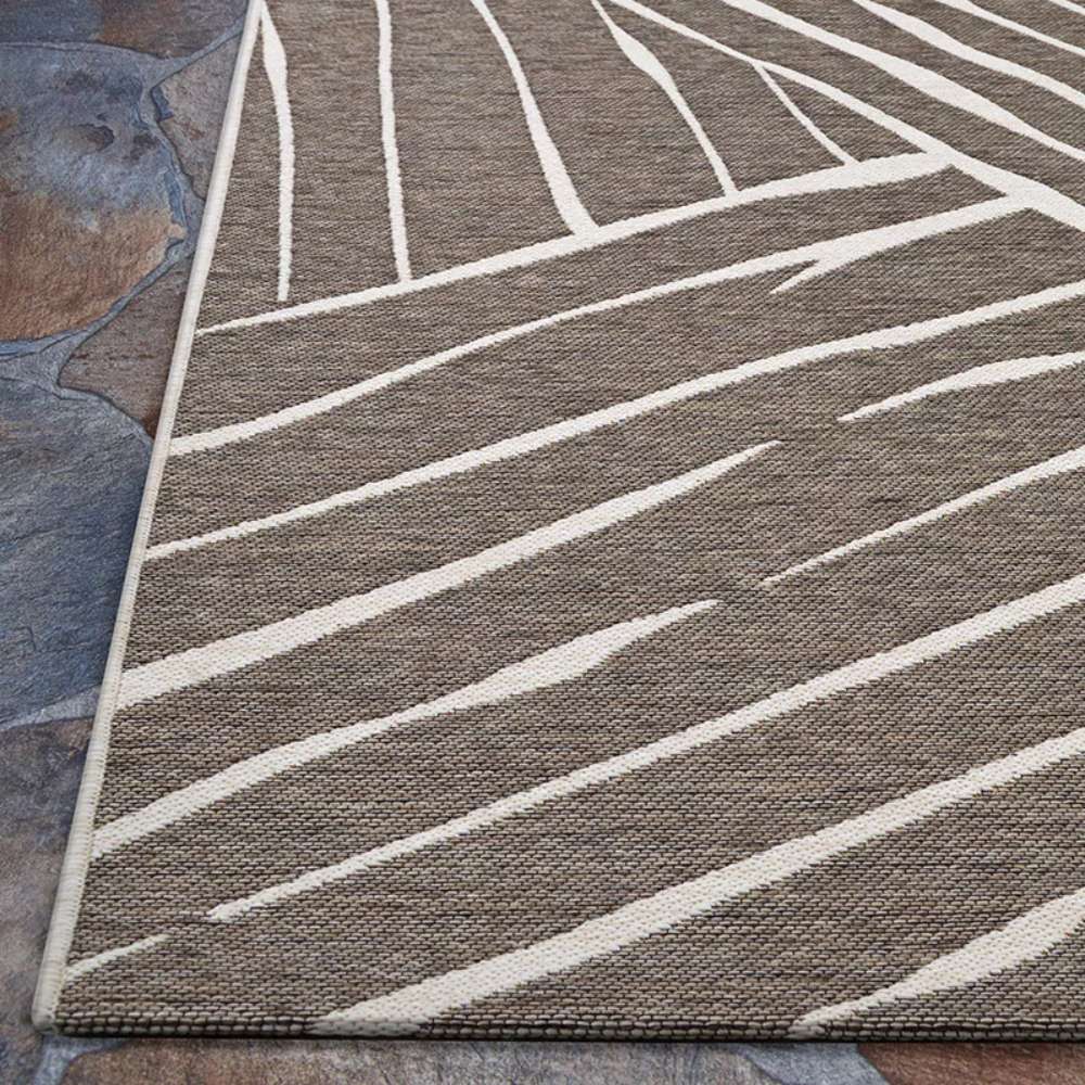 Side view of Couristan Dolce Indoor/Outdoor Rug - Parquet/Mocha reveals its smooth weave and sharp diagonal lines across a mocha base