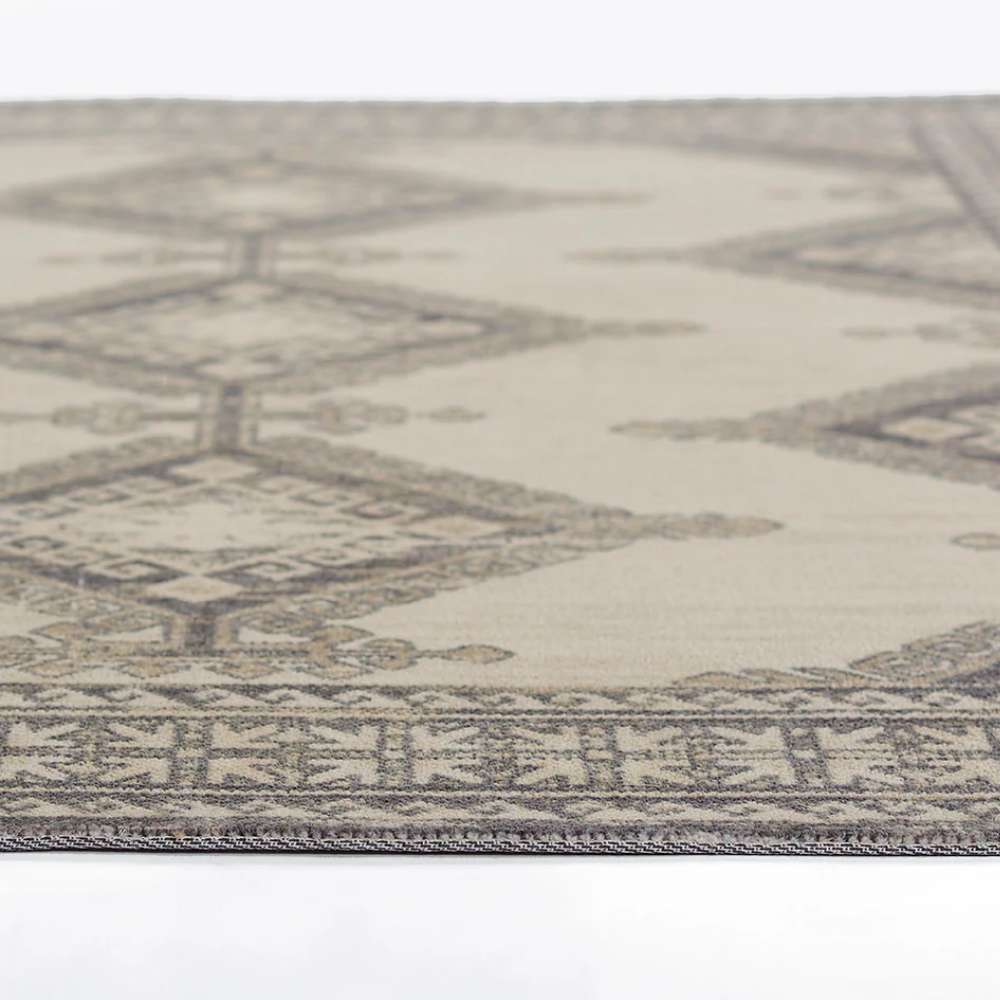 Side view of Momeni Anatolia Indoor Rug - ANA-10 Charcoal, displaying its flat, smooth surface and elegant geometric pattern layout