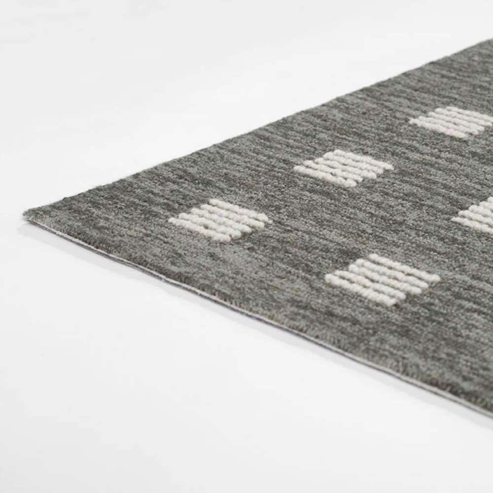 Side view of Momeni Archer Indoor Rug - ARC-1 Charcoal shows its slim, flatwoven profile and durable structure