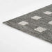 Side view of Momeni Archer Indoor Rug - ARC-1 Charcoal shows its slim, flatwoven profile and durable structure
