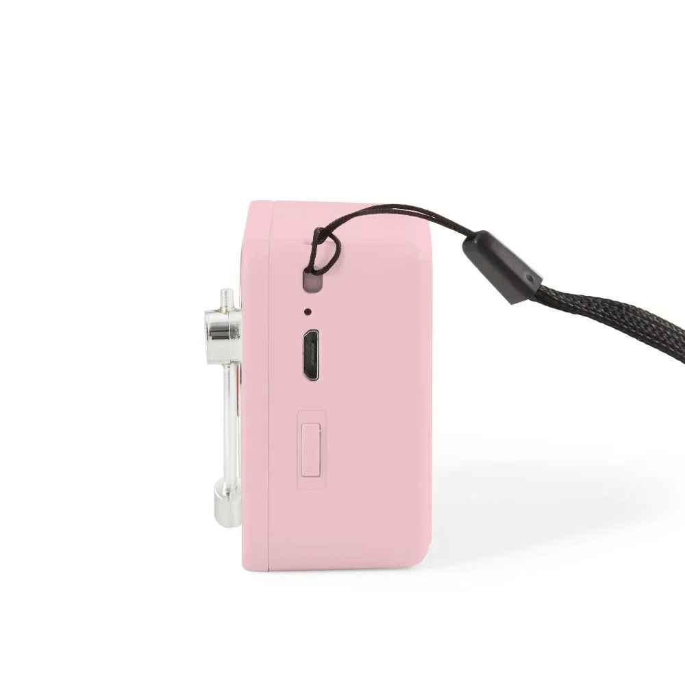 Side view of the Crosley Mini Turntable Bluetooth Speaker - Pink shows a charging port, power switch, and strap attachment