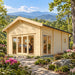 Front-and-side view of the Sigrid 70 Freedom House in western North Carolina, surrounded by rhododendrons, native woodland and layered Blue Ridge Mountains, with a professional working inside the bright glass-fronted office.