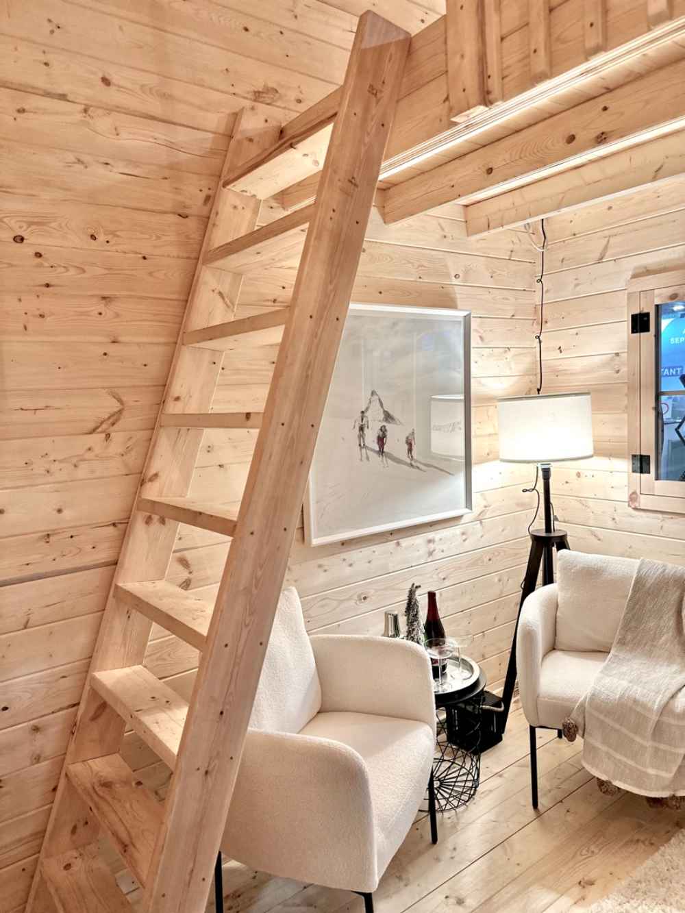 Simple wooden ladder leads to the upper loft area inside the Sawmill Structures Ontario Grand Loft 107 SD Garden Room