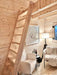 Simple wooden ladder leads to the upper loft area inside the Sawmill Structures Ontario Grand Loft 107 SD Garden Room