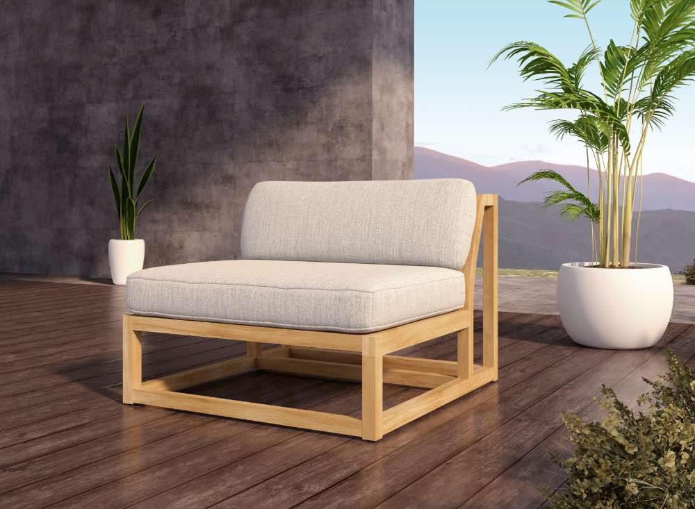 Single Westminster Teak Maya Slipper Chair with light cushions sits on a wooden deck beside potted plants with mountains in the background