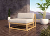 Single Westminster Teak Maya Slipper Chair with light cushions sits on a wooden deck beside potted plants with mountains in the background