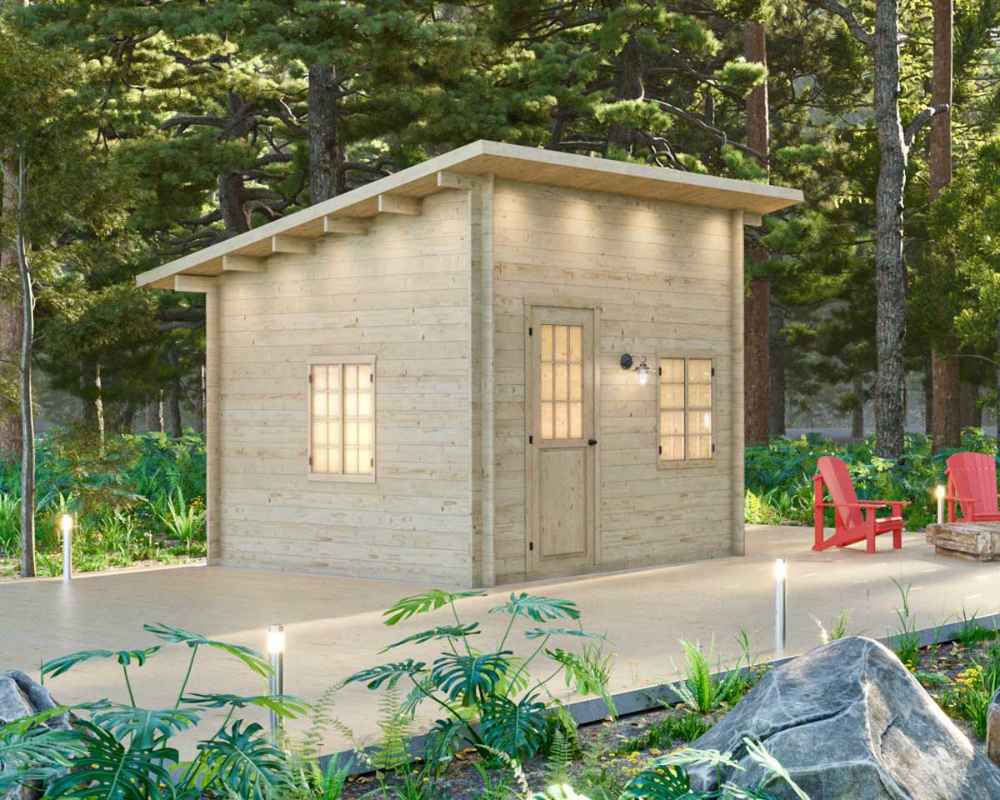 Single-room wooden cabin with a slanted roof sits on a wooden deck surrounded by tall forest trees—this is the Sawmill Structures Multi Cube Versa 100 Garden Room