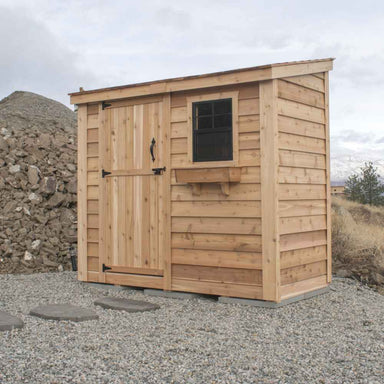 Single Door Cedar Roof Outdoor Living Today 8×4 SpaceSaver Lean-To Cedar Shed displayed with a small window beside a sturdy cedar door against a rocky, outdoor backdrop