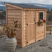 Single Door Metal Roof Outdoor Living Today 8×4 SpaceSaver Lean-To Cedar Shed displays a rustic cedar finish, metal roof, and window flower box beside a decorative planter on gravel