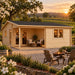 Skanderborg 44 Freedom Suite glowing at sunset in North Carolina’s Yadkin Valley, surrounded by vineyard rows, flowering dogwoods and mature oaks, with an upscale entertainment bar and two adults visible inside.