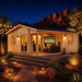 Skanderborg 90 glowing brightly at night as family and friends watch sports, surrounded by illuminated desert landscaping and Arizona red-rock formations.
