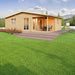 GardenHouse24 USA Skanderborg 90 Garden Room is depicted with flowers, mountains in the background, and a relaxing natural atmosphere