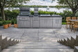 Sleek lakeside outdoor kitchen featuring the Sunstone Alamo 10ft Outdoor Cabinet Island Package with Hybrid Grill
