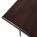 Smooth dark wood top of Crate & Barrel Sedgwick Solid Acacia Wood Desk with Storage is shown in a close-up of its finished edge