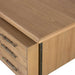 Smooth oak top and clean side profile of Crate & Barrel Sedgwick Solid Oak Wood Desk with Storage are shown in a close-up