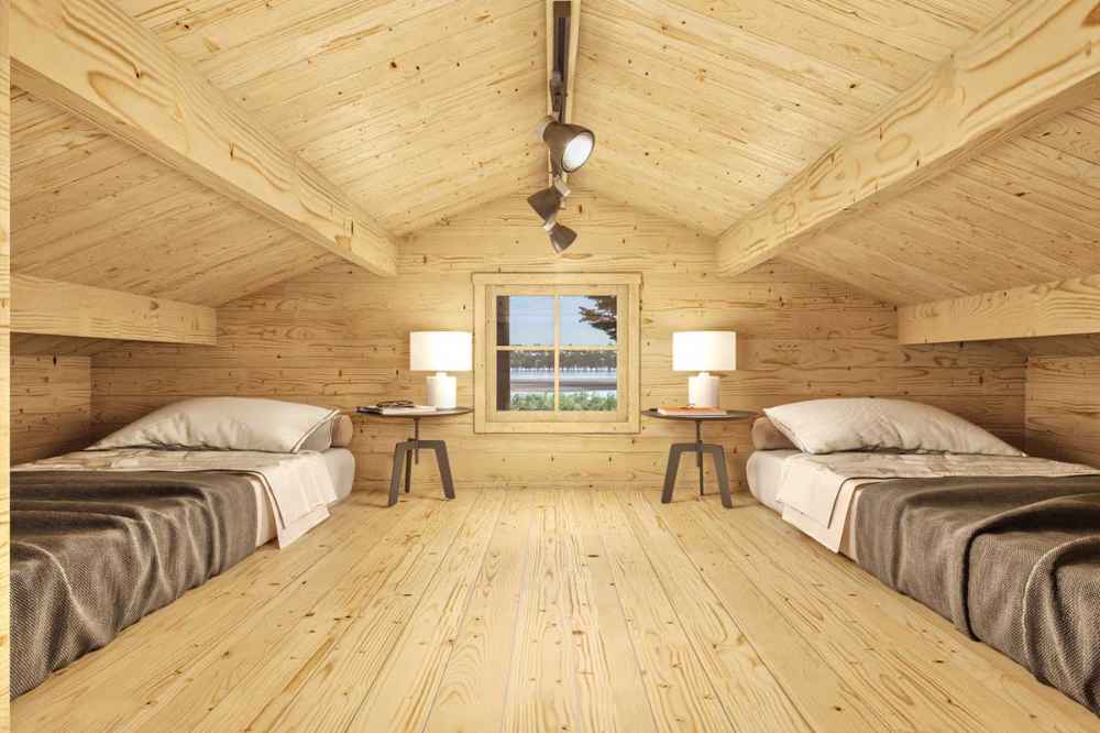 Spacious loft in the Sawmill Structures Edwin Lake House PLUS 70MM Garden Room has two single beds on either side, with a central window and soft lighting