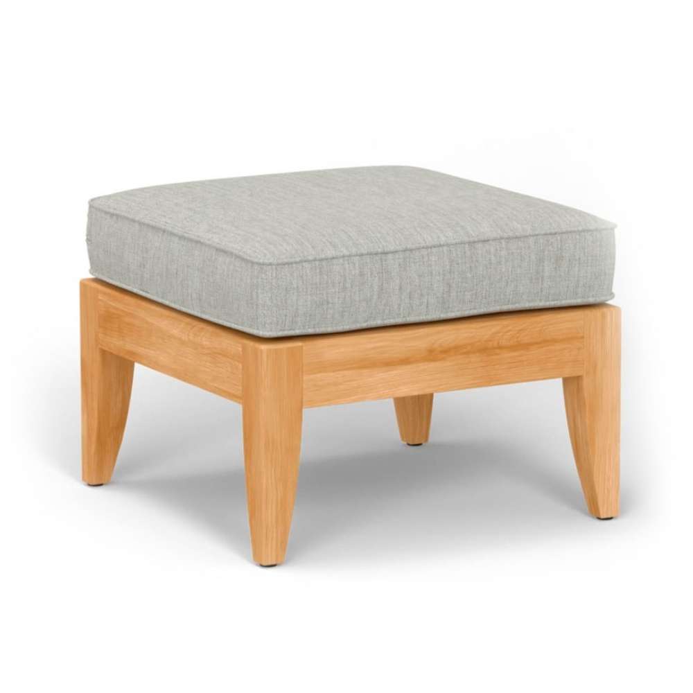 Square wooden stool with a light gray cushion on top, labeled as Westminster Teak Laguna Ottoman, shown against a plain background