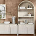 Styled Crate & Barrel Annie 38" Whitewashed Wood Storage Bookcase with Shelves displaying books, ceramics, and decorative objects