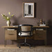 Styled in a warm home office, Crate & Barrel Sedgwick Solid Oak Wood Desk with Storage is paired with a woven office chair and decorative accessories