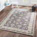 Styled in a bright living room, Momeni Anatolia Indoor Rug - ANA-8 Charcoal adds elegance with its bold charcoal center and light border