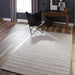 Styled in a bright living room, Momeni Andes Indoor Rug - AND-4 Light Grey brings a cozy yet modern touch to wood flooring