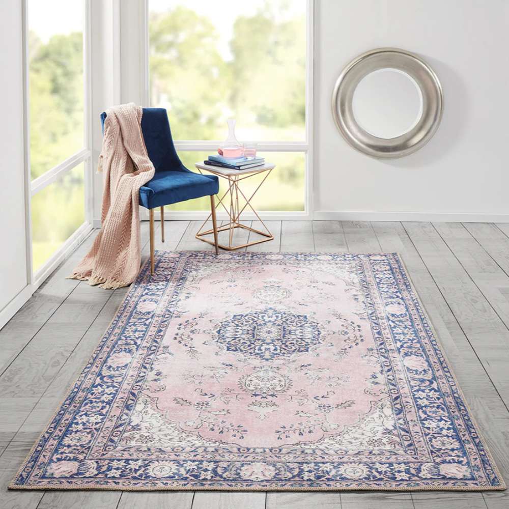Styled in a bright room, Momeni Afshar Indoor Rug - AFS30 Pink adds elegance with its soft pink background and bold navy blue accents