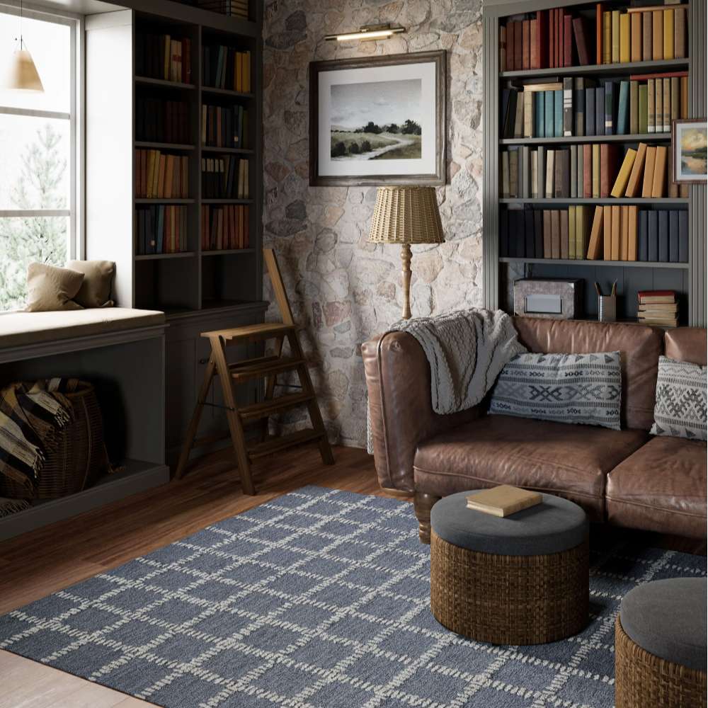 Styled in a cozy library living room, Momeni Archer Indoor Rug - ARC-3 Blue adds warmth and modern charm beneath a leather sofa and bookshelves