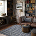 Styled in a cozy library living room, Momeni Archer Indoor Rug - ARC-3 Blue adds warmth and modern charm beneath a leather sofa and bookshelves