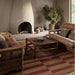 Styled in a cozy living room, Momeni Adobe Indoor Rug - ADO-1 Red adds warmth and rustic charm beneath wood furniture and neutral tones