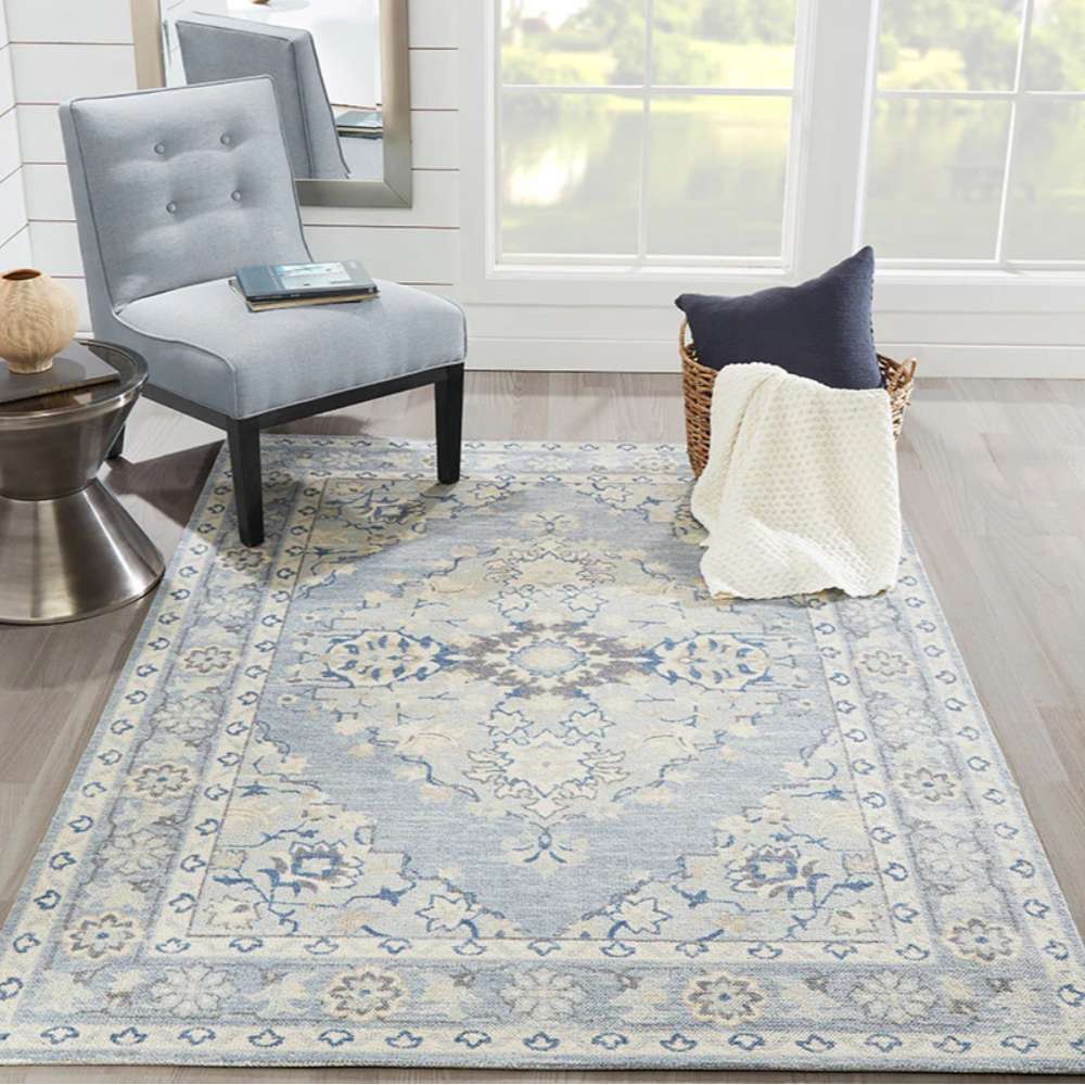 Styled in a cozy living room, Momeni Anatolia Indoor Rug - ANA-9 Blue adds warmth and elegance with its soft blue palette and traditional design