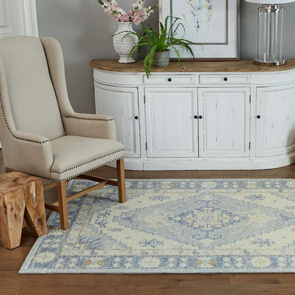Styled in a cozy room, the Momeni Anatolia Indoor Rug - ANA-1 Blue adds elegance with its soft blue and ivory hues