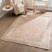 Styled in a living room, Momeni Anatolia Indoor Rug - ANA-8 Pink adds warmth and color with its vintage design and soft pastel hues