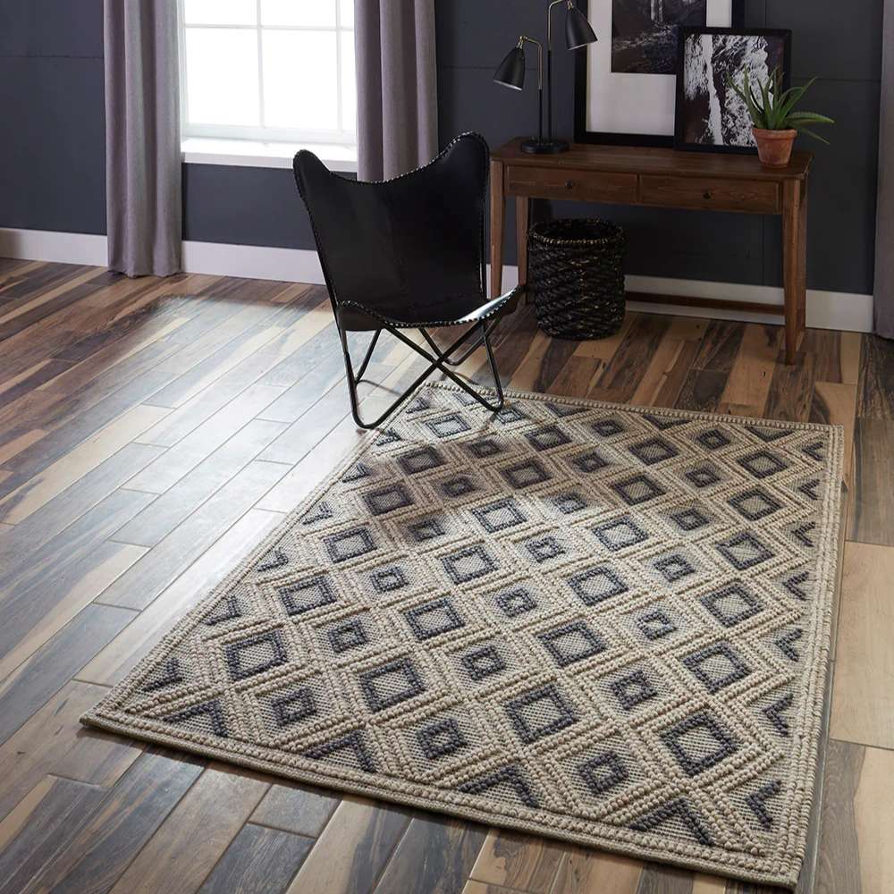 Styled in a modern living room, Momeni Andes Indoor Rug - AND-2 Beige complements wood floors