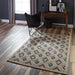 Styled in a modern living room, Momeni Andes Indoor Rug - AND-2 Beige complements wood floors