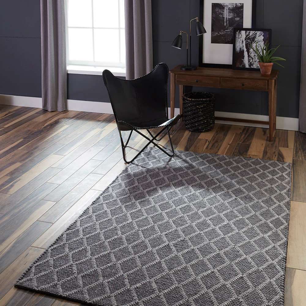 Styled in a modern living space, Momeni Andes Indoor Rug - AND-7 Charcoal adds warmth and elegance with its geometric pattern