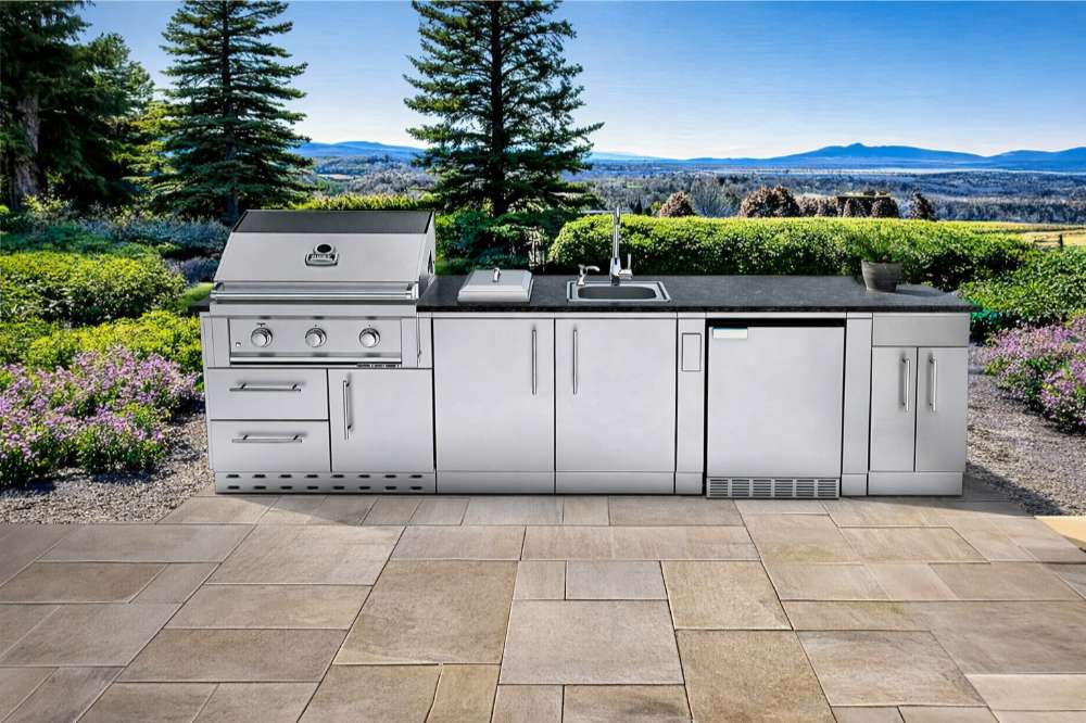 Sunstone Bayou 8ft 6in Outdoor Kitchen Island Package on a patio with mountain views, featuring grill, sink, and fridge