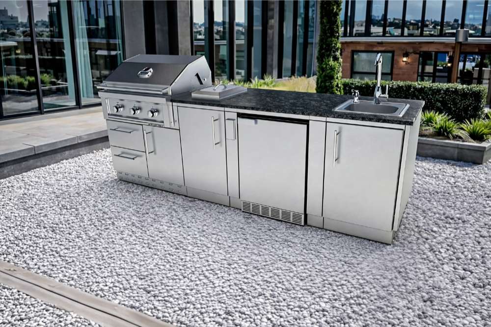 Sunstone Bayou 8ft 6in Outdoor Kitchen Island Package on a rooftop terrace with grill, sink, and modern storage