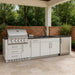 Sunstone Intermediate 9ft Outdoor Grill & Cabinet Island Package features a built-in stainless steel grill, sink, fridge, and storage in a sleek outdoor setup