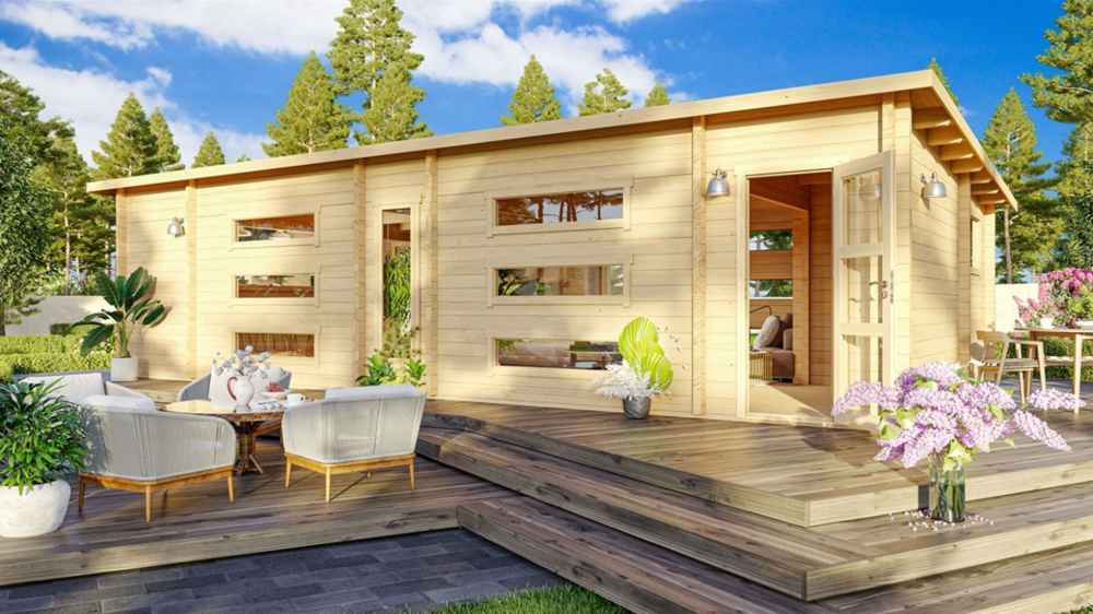 Surrounded by flowers and trees, the GardenHouse24 USA Dundee 90A Garden Room features a spacious deck, modern seating, and double glass doors