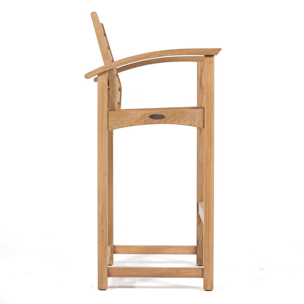 Tall teak bar stool with curved arms and a slatted back from Westminster Teak Somerset 5pc Teak High Bar Set is shown from the side with a sturdy footrest