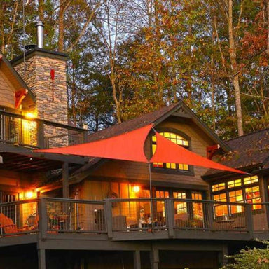 Tenshon Right Triangle Shade Sail mounted above a wooden deck at a cabin-style home